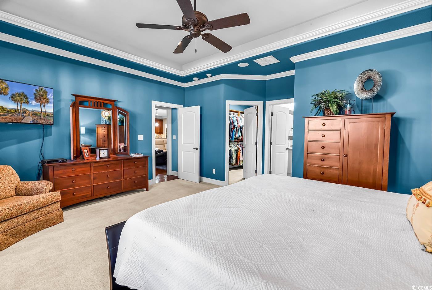 956 Corrado Street Myrtle Beach, SC 29572 - Photo 18 of 38 Bedroom featuring ornamental molding, carpet, a walk in closet, ceiling fan, and ensuite bath