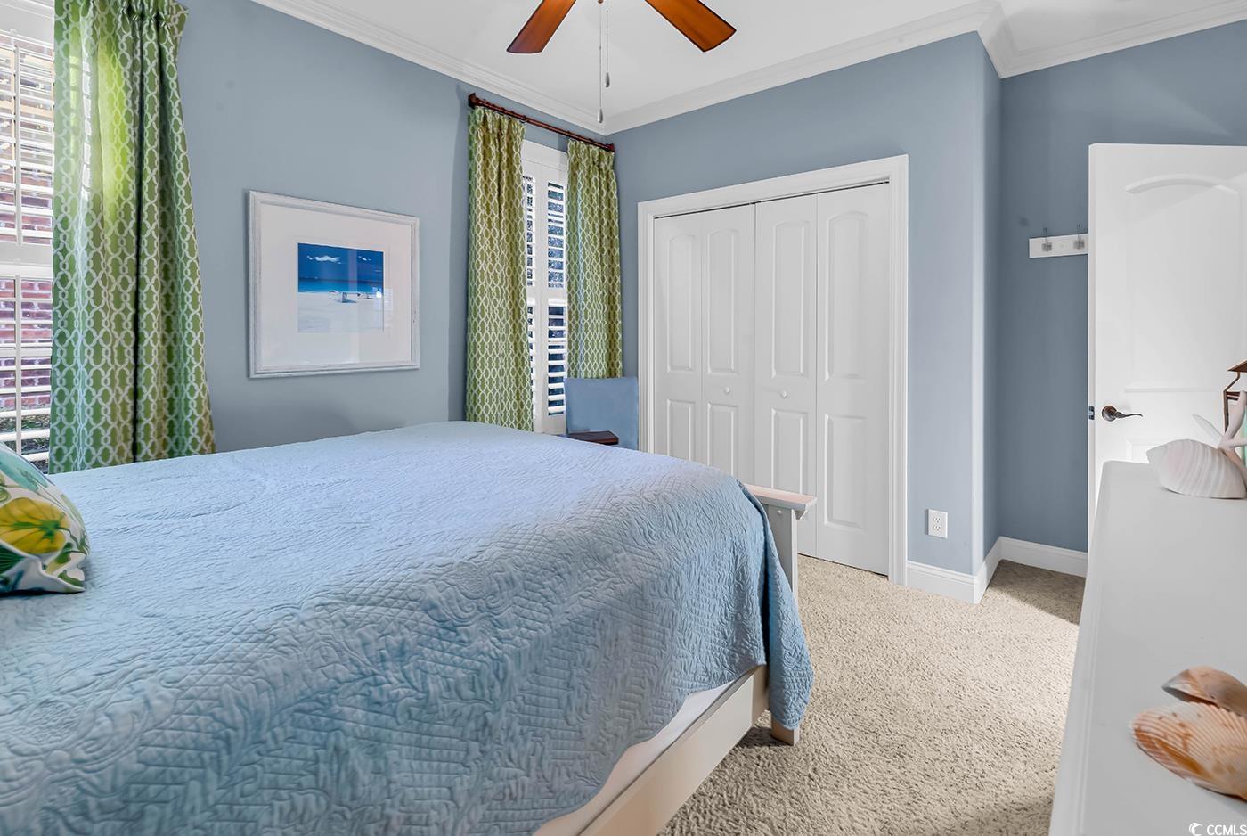 956 Corrado Street Myrtle Beach, SC 29572 - Photo 24 of 38 Bedroom featuring ornamental molding, carpet floors, a closet, and a ceiling fan