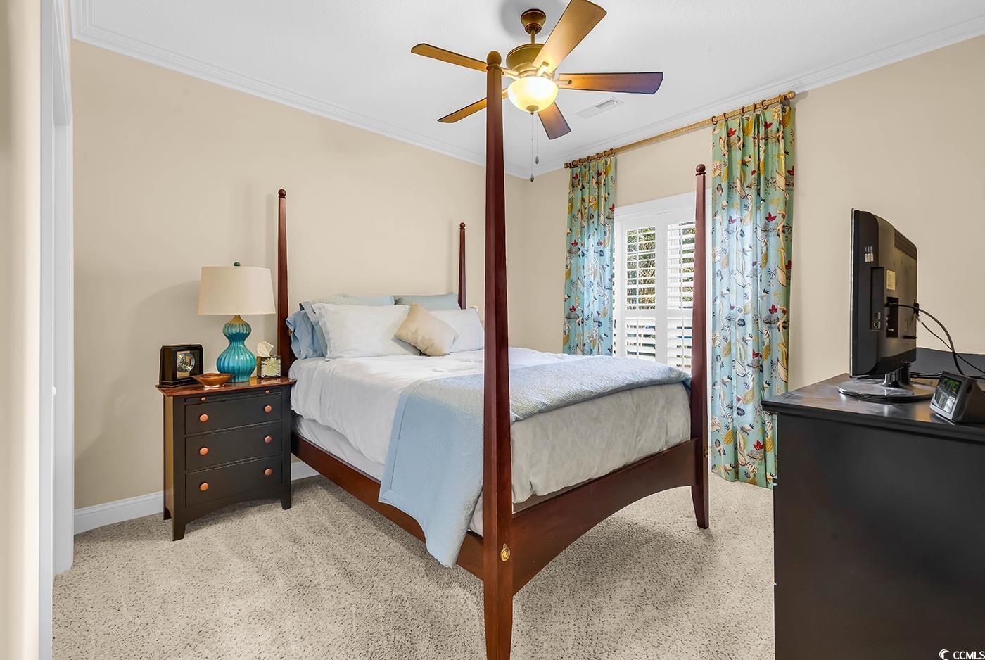 956 Corrado Street Myrtle Beach, SC 29572 - Photo 25 of 38 Bedroom featuring crown molding, light carpet, and a ceiling fan