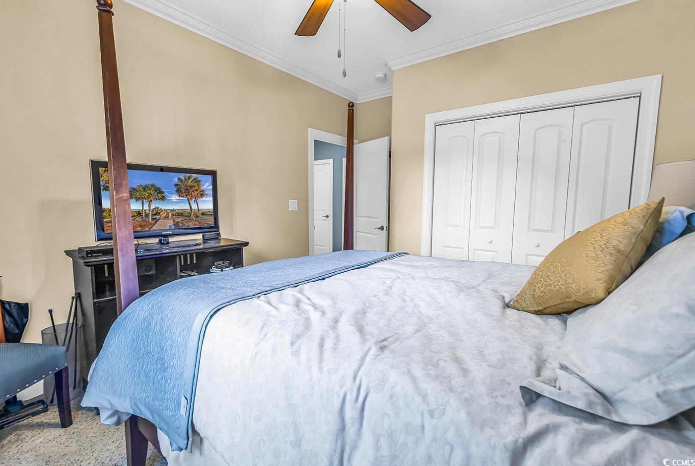 956 Corrado Street Myrtle Beach, SC 29572 - Photo 26 of 38 Carpeted bedroom with crown molding, a ceiling fan, and a closet