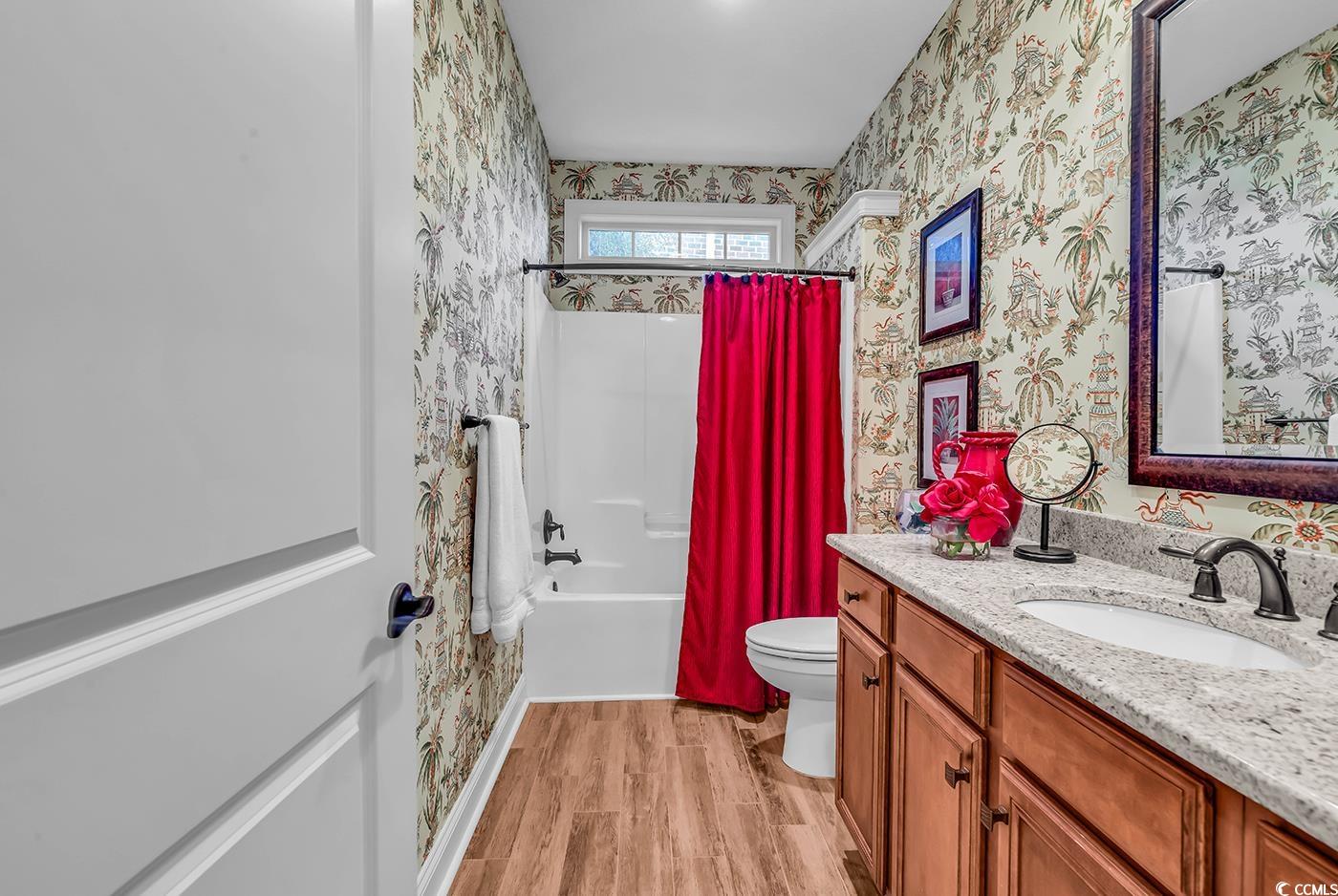 956 Corrado Street Myrtle Beach, SC 29572 - Photo 27 of 38 Full bathroom featuring shower / bathtub combination with curtain, vanity, light wood finished floors, and wallpapered walls