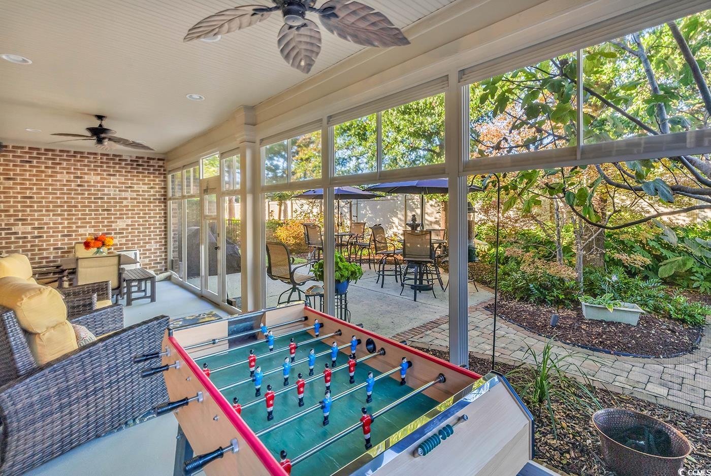 956 Corrado Street Myrtle Beach, SC 29572 - Photo 32 of 38 Sunroom / solarium featuring outdoor dining space, ceiling fan, and a patio