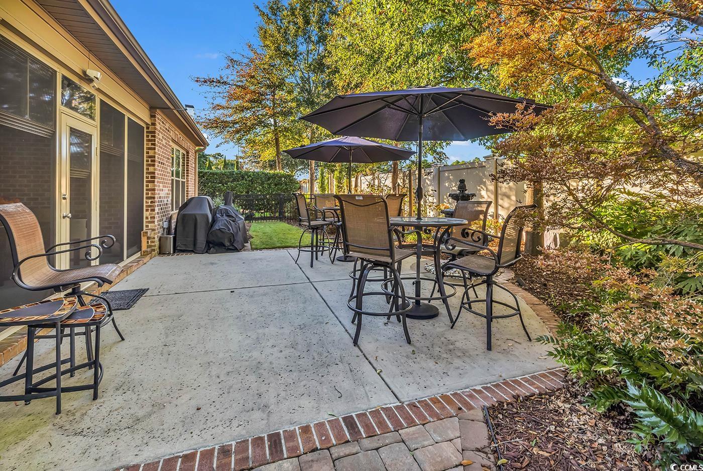 956 Corrado Street Myrtle Beach, SC 29572 - Photo 33 of 38 Fenced backyard featuring a patio area, outdoor dining space, and a grill