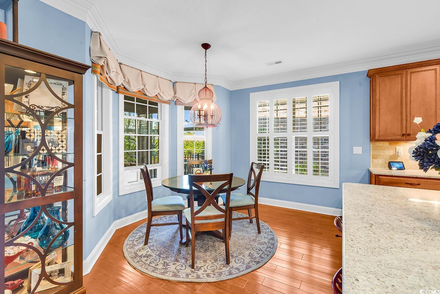 956 Corrado Street Myrtle Beach, SC 29572 - Photo 9 of 38 Dining room with light wood-style floors, a chandelier, and ornamental molding