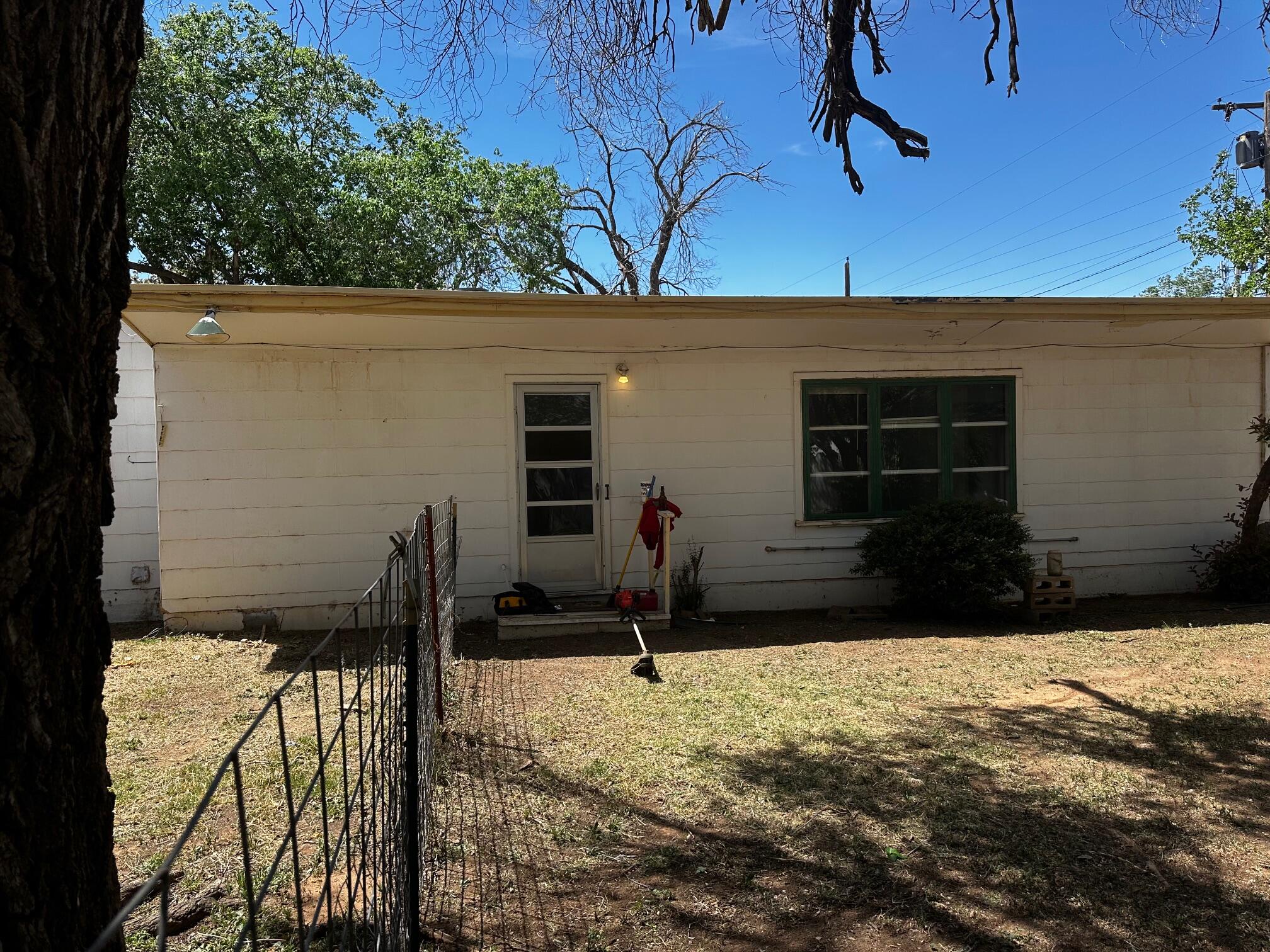 2402 25th Street Lubbock, TX 79411 - Photo 2 of 3 a backyard of a house with table and chairs