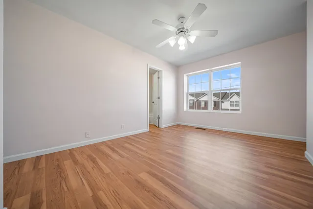 wooden floor in an empty room with a window