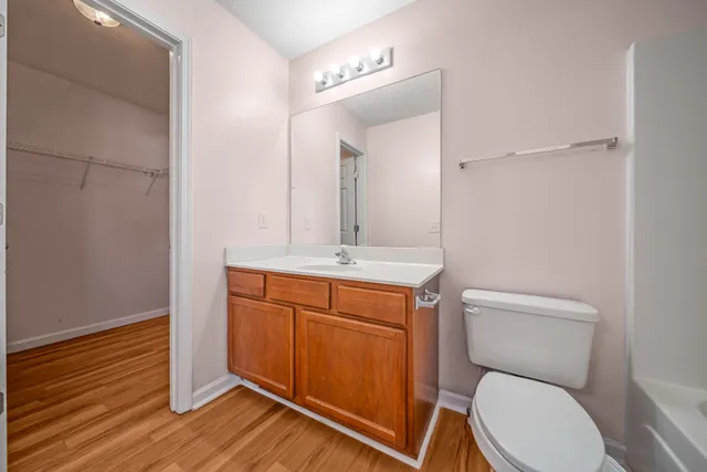 a bathroom with a toilet a sink and mirror