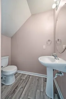 a bathroom with a sink toilet and a mirror