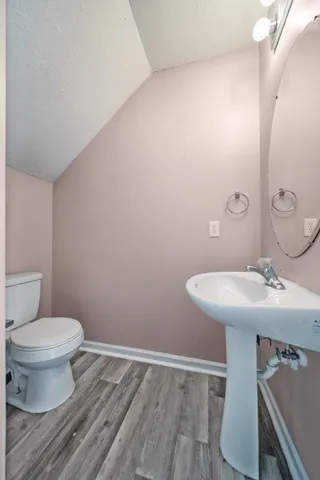 a bathroom with a sink toilet and a mirror