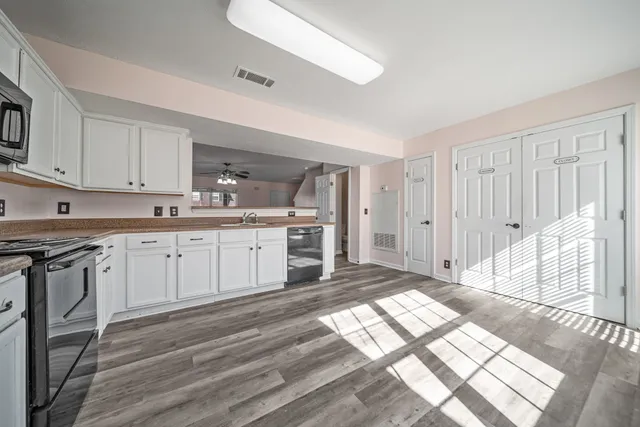 a kitchen with a sink stove and cabinets