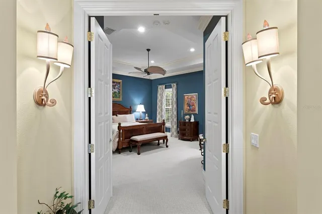 a living room with furniture a mirror and a glass door