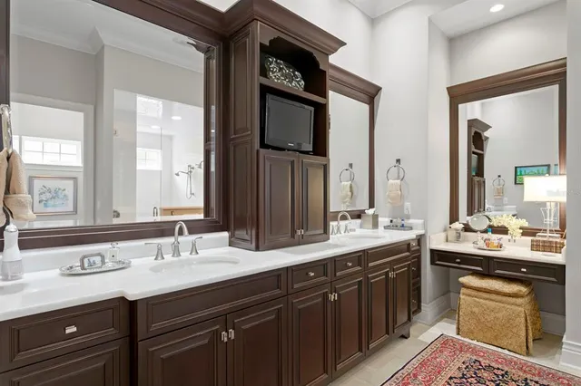 a bathroom with a double vanity sink and a mirror