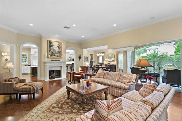 a living room with fireplace furniture and a floor to ceiling window