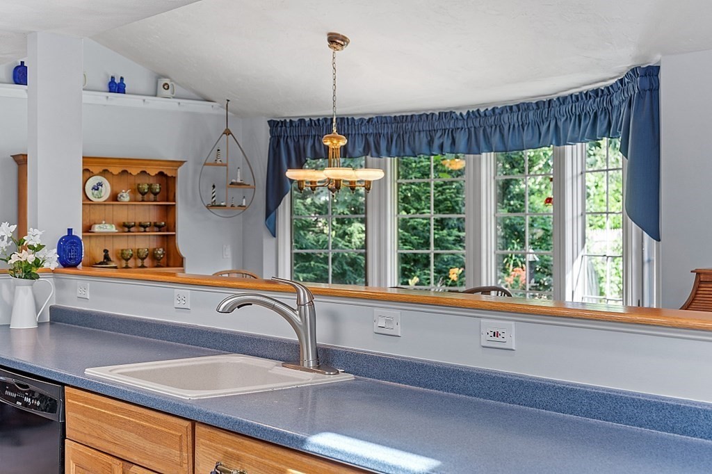 6 Wildes Road Chelmsford, MA 01824 - Photo 8 of 42 a kitchen with a large window and a sink