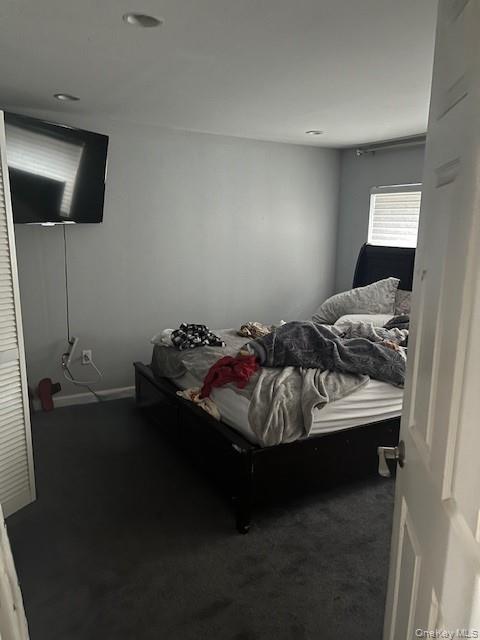 226 14th Avenue West Babylon, NY 11704 - Photo 17 of 27 a bed sitting in a bedroom next to a window