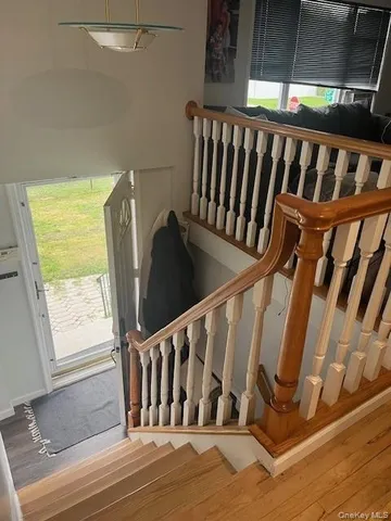 a view of staircase with railing and white walls