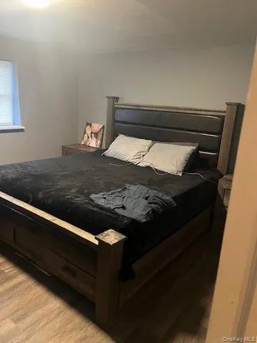 a bed sitting in a bedroom next to a window