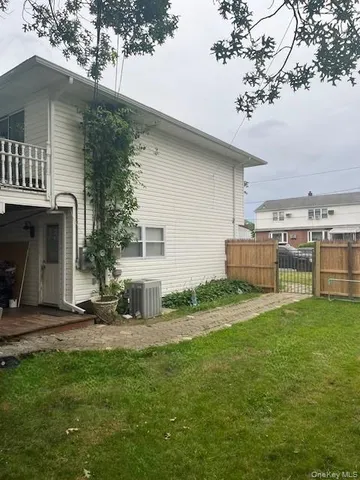 a backyard of a house with table and chairs