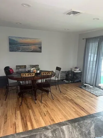 a dining room with furniture and wooden floor