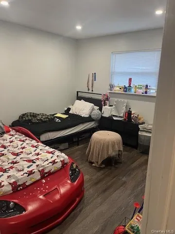 a bedroom with bed and a night stand