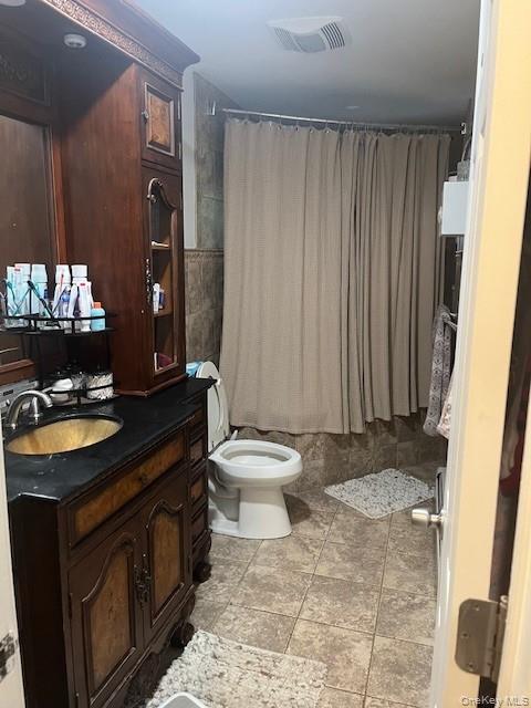 226 14th Avenue West Babylon, NY 11704 - Photo 10 of 27 a bathroom with a toilet sink and mirror