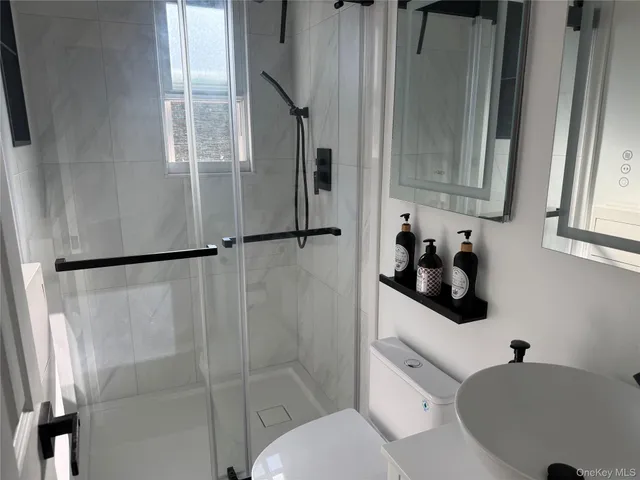 a bathroom with a toilet sink and shower