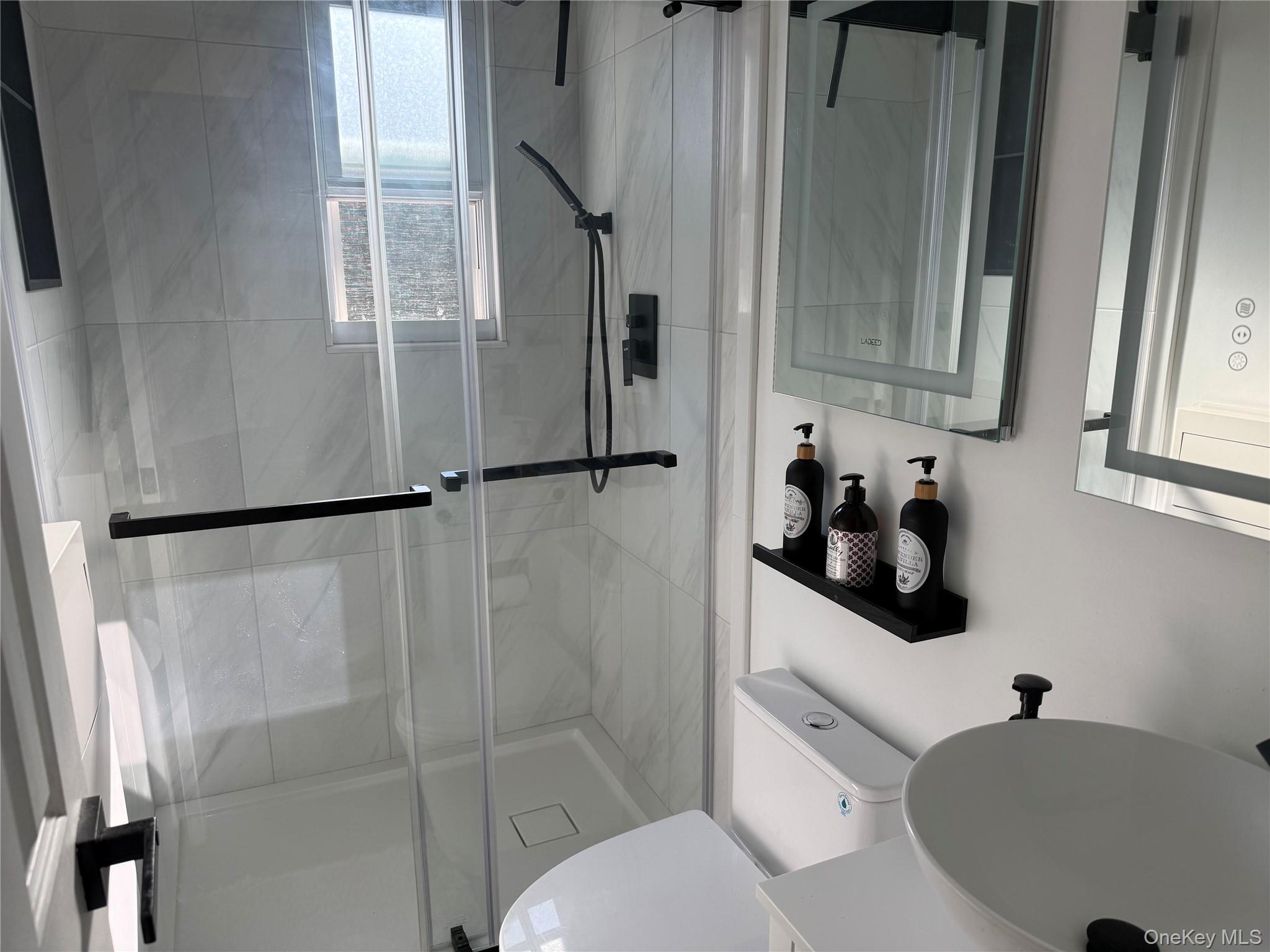 37 D Carpenter Avenue, Unit 37D Mount Kisco, NY 10549 - Photo 11 of 14 a bathroom with a toilet sink and shower