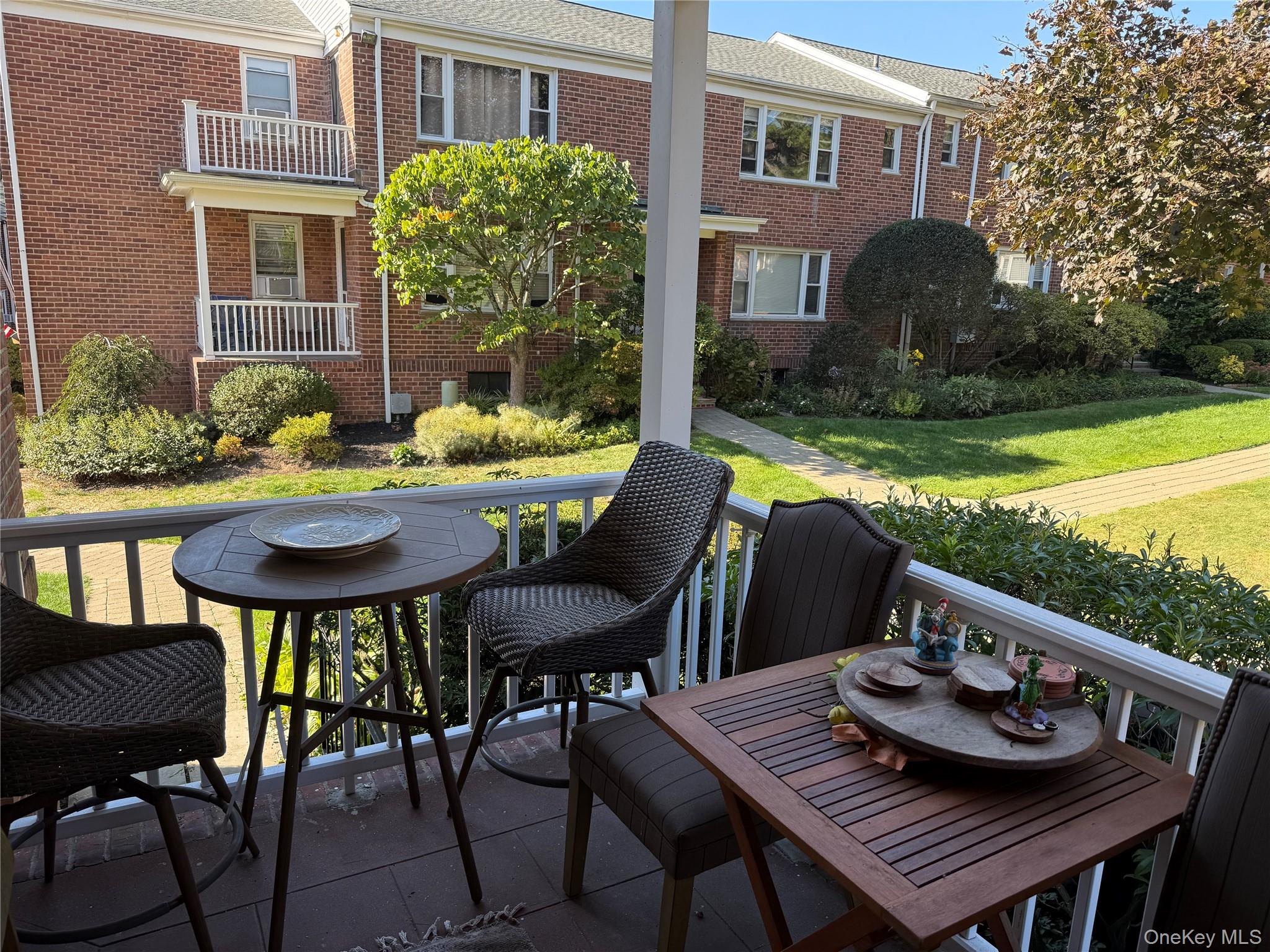 37 D Carpenter Avenue, Unit 37D Mount Kisco, NY 10549 - Photo 12 of 14 a view of a patio with table and chairs and potted plants