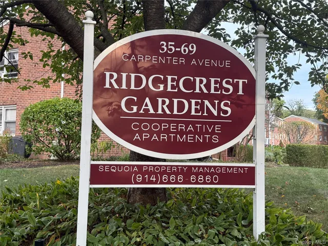 a sign broad in front of red brick house