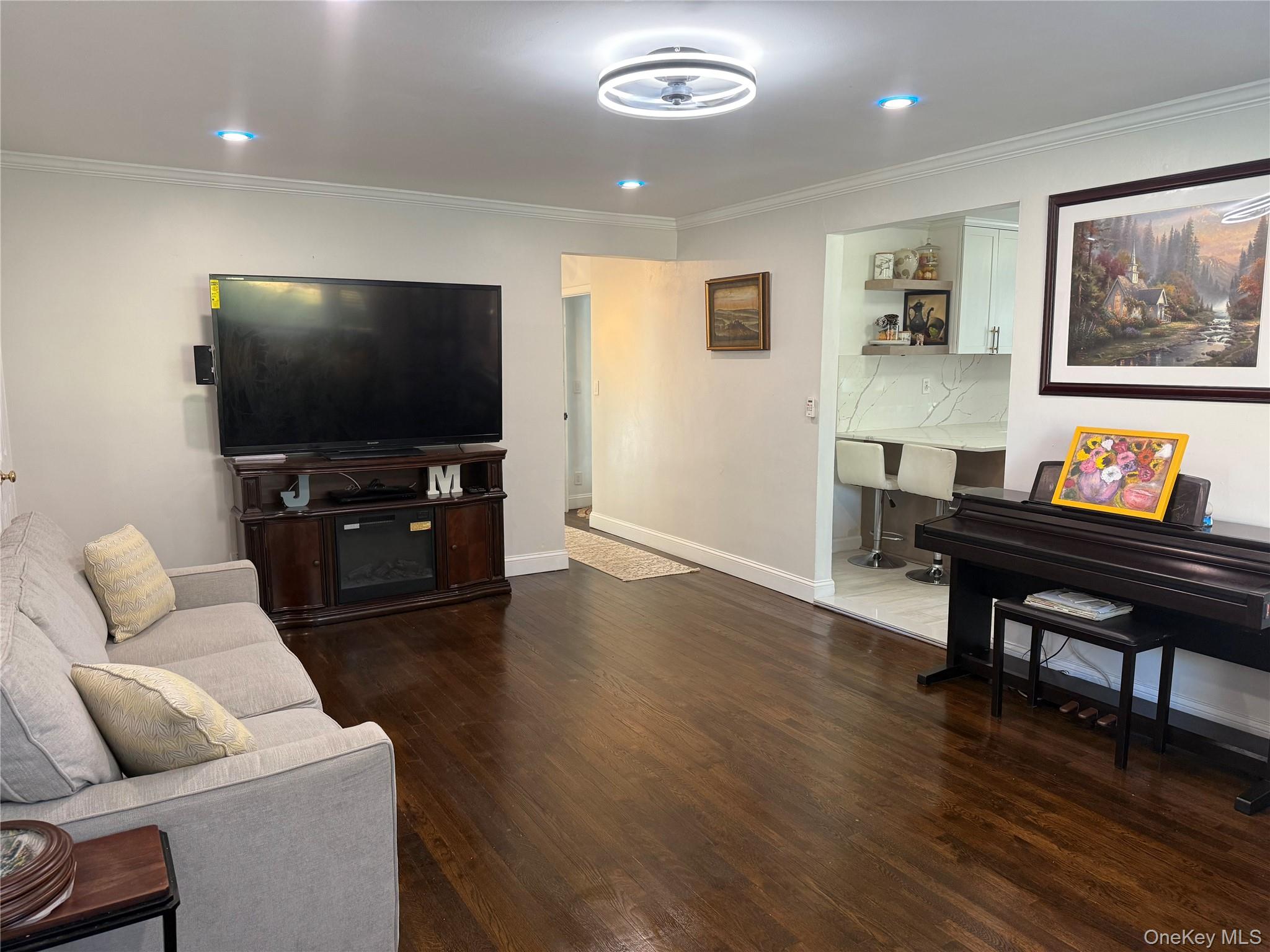 37 D Carpenter Avenue, Unit 37D Mount Kisco, NY 10549 - Photo 3 of 14 a living room with furniture and a flat screen tv