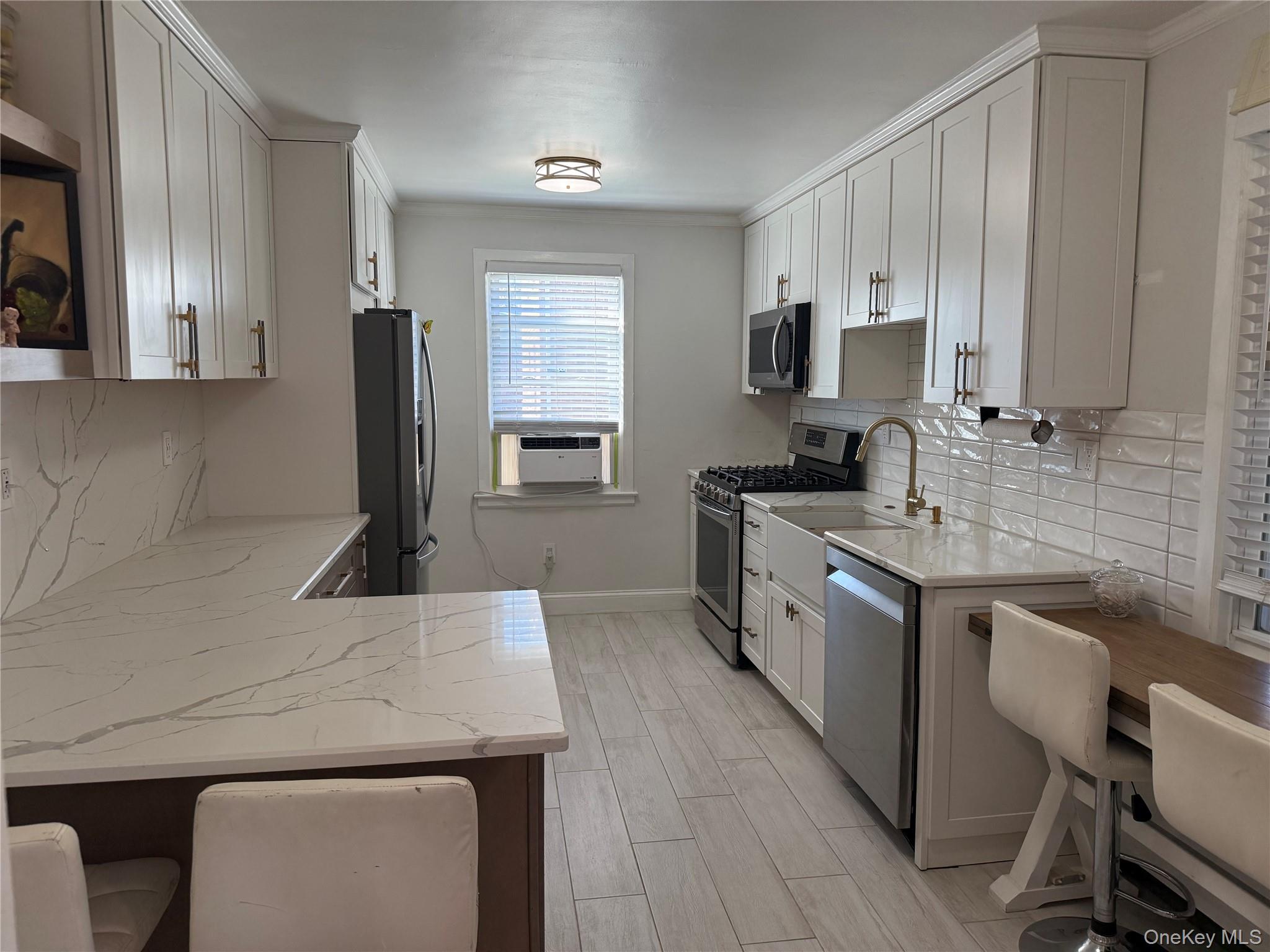 37 D Carpenter Avenue, Unit 37D Mount Kisco, NY 10549 - Photo 5 of 14 a kitchen with a sink stove and cabinets