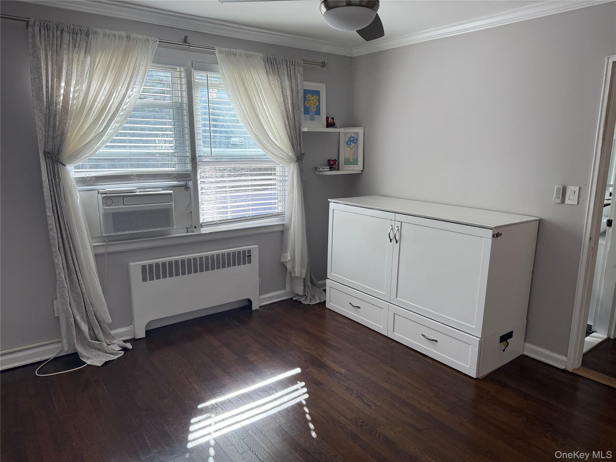 37 D Carpenter Avenue, Unit 37D Mount Kisco, NY 10549 - Photo 9 of 14 an empty room with wooden floor and windows