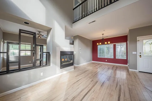 a view of empty room with wooden floor and fireplace