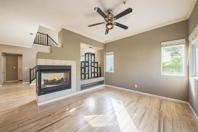 a view of an empty room with window and fire place