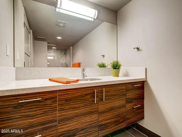 a bathroom with a sink and a mirror