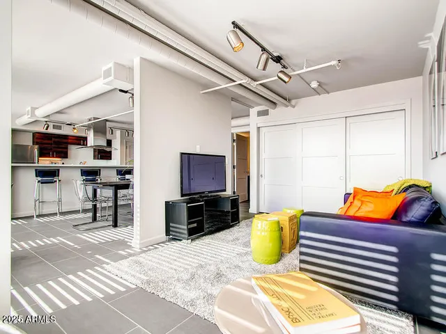 a bedroom with furniture and a flat screen tv