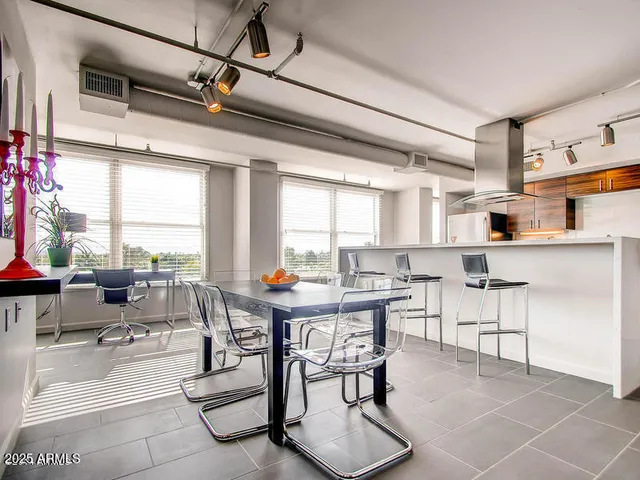 a view of a dining room with furniture and a large window