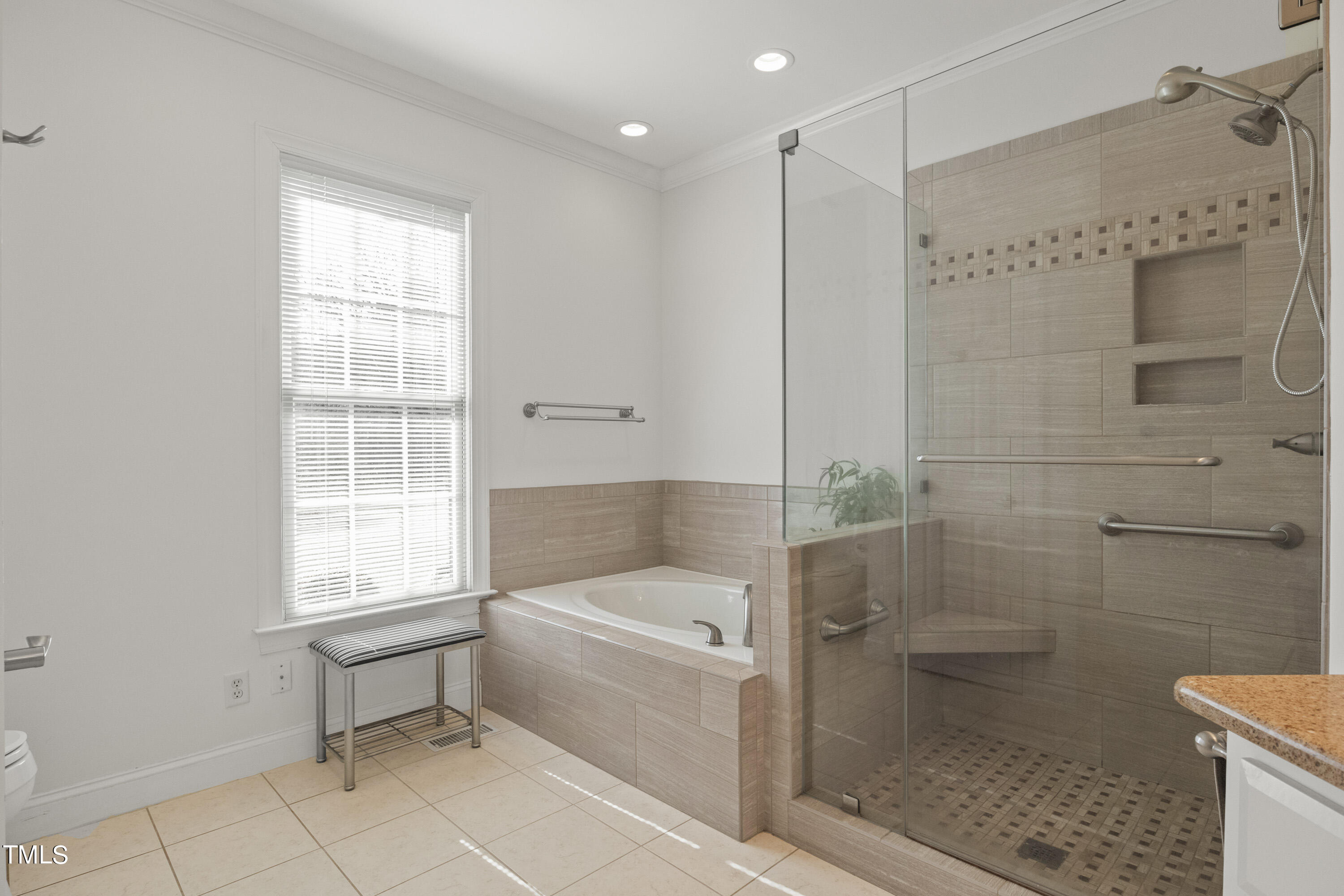 5504 Yates Mill Pond Road Raleigh, NC 27606 - Photo 22 of 56 a bathroom with a bathtub and a shower