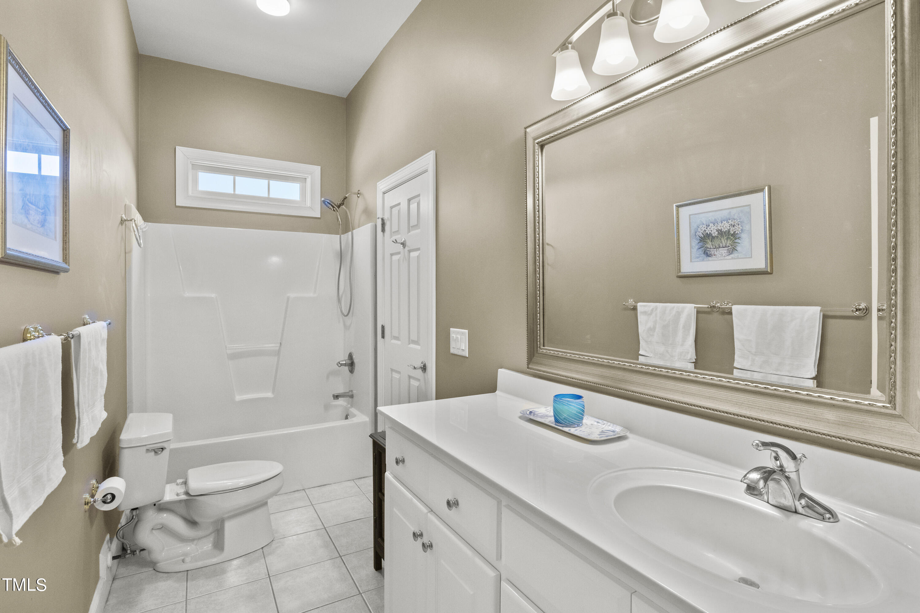 5504 Yates Mill Pond Road Raleigh, NC 27606 - Photo 36 of 56 a bathroom with a granite countertop sink toilet a large mirror a shower and a mirror