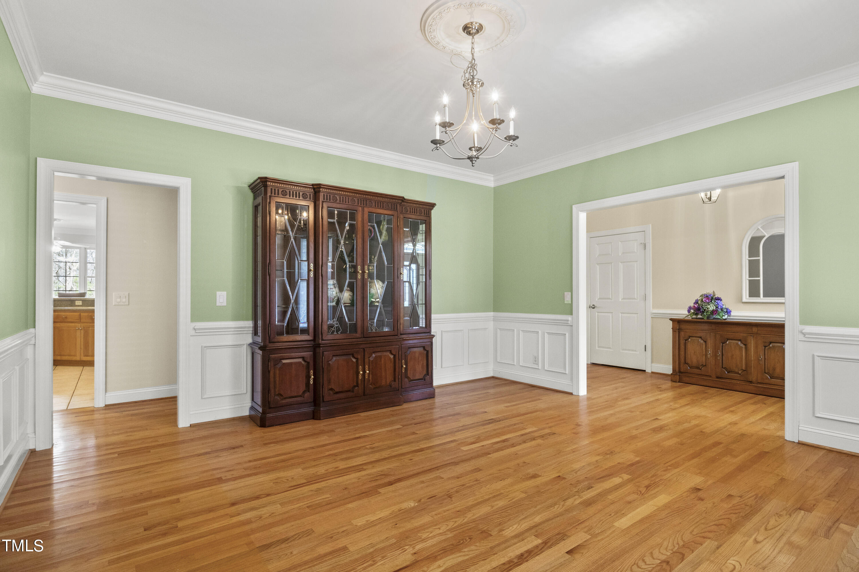 5504 Yates Mill Pond Road Raleigh, NC 27606 - Photo 9 of 56 a view of a livingroom with wooden floor and kitchen space