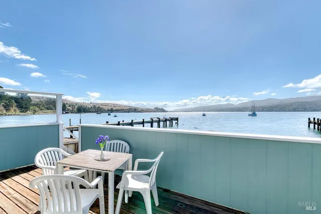 a balcony with a table and chairs