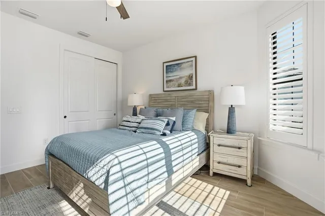 a bedroom with a bed and a night stand