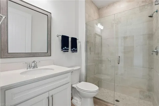 a bathroom with a sink toilet a mirror and shower