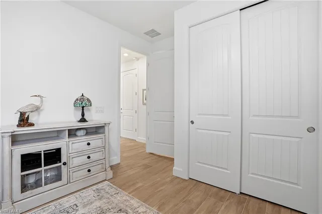 a view of hallway with mirror and a window