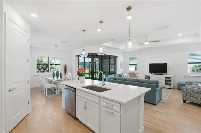 a kitchen with sink stove and living room