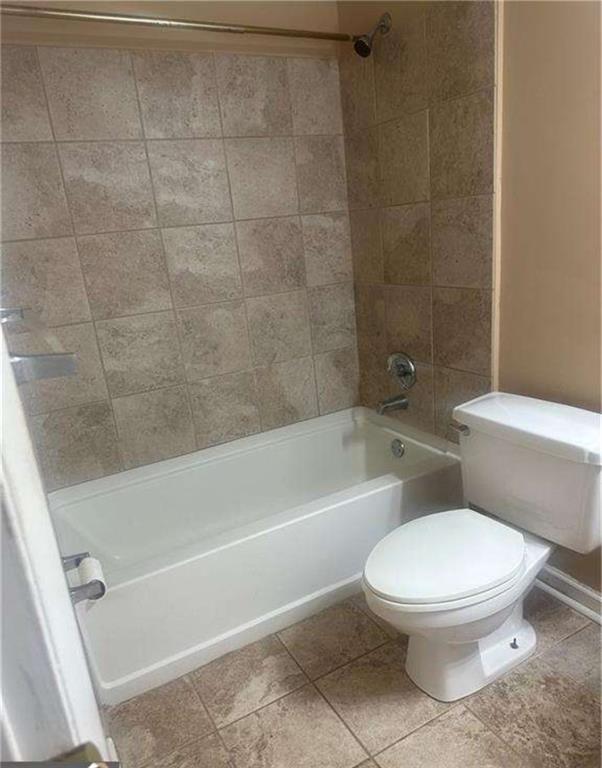 795 Hammond Drive, Unit 210 Atlanta, GA 30328 - Photo 13 of 18 a white toilet and tub sitting next to a bathroom sink