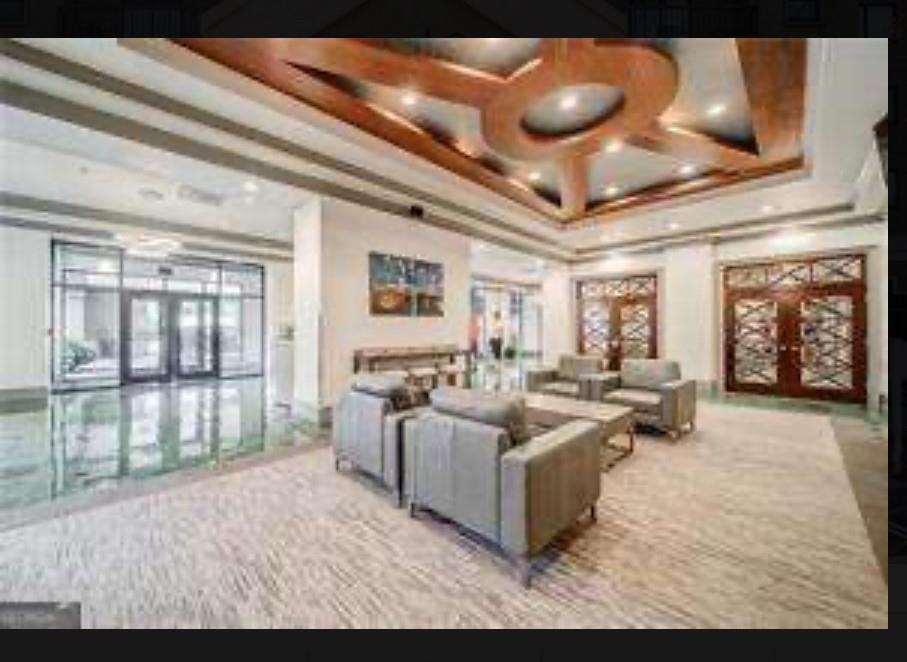 795 Hammond Drive, Unit 210 Atlanta, GA 30328 - Photo 3 of 18 a living room with furniture and a large window