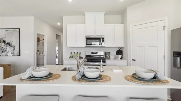 a kitchen with a sink and wooden cabinets