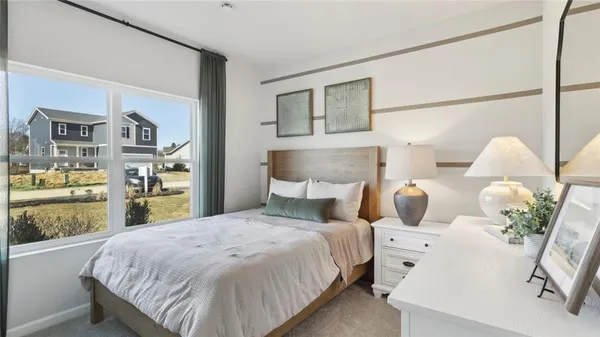 a bed room with two bed and a potted plant