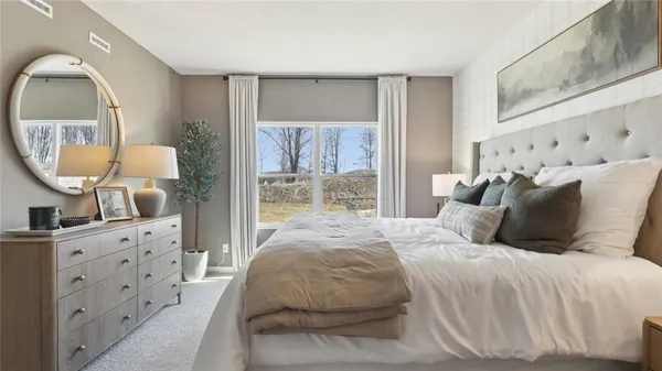 a bedroom with a large bed and a mirror